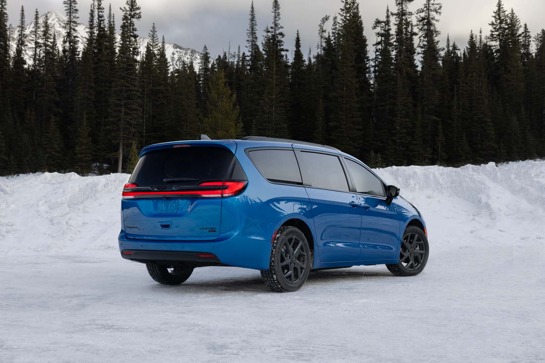 2027 Chrysler Pacifica Limited AWD parked in deep winter snow in the mountains